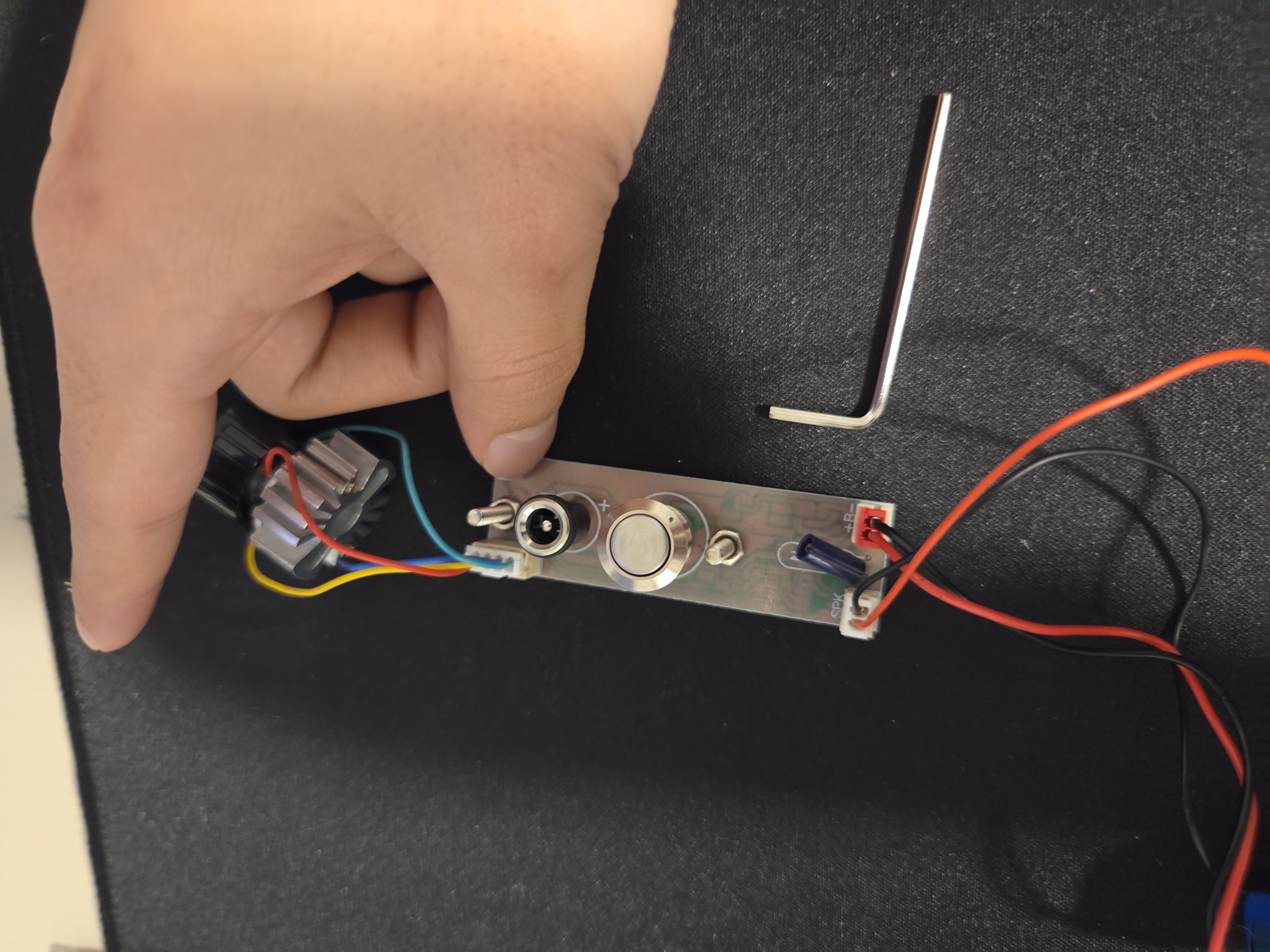 Close detail of a hand testing a circuit module.